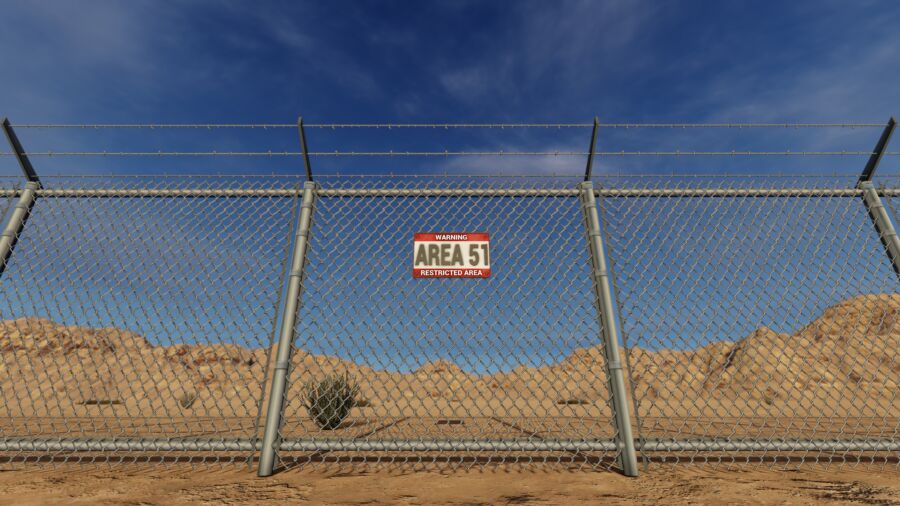 Fenced-off warning sign at Area 51, displaying a caution and clear text to deter unauthorized entry