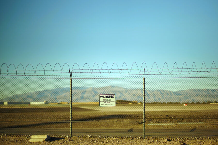 Warning sign indicating a fenced-off area at Area 51, featuring bold text