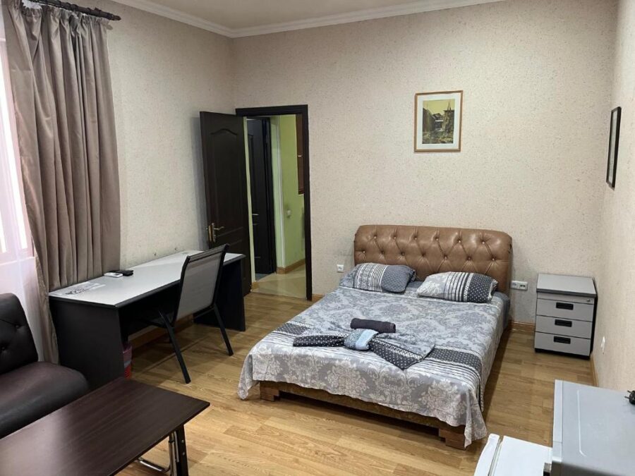 Well-furnished room at The Nut Guest House in Yerevan, Armenia, showcasing a comfortable bed and inviting decor.