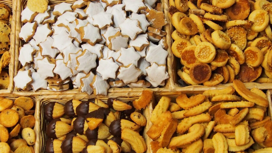 Artisan assorted cookies in woven baskets, bredele, chocolate-dipped, iced shortbread for holiday bakery.