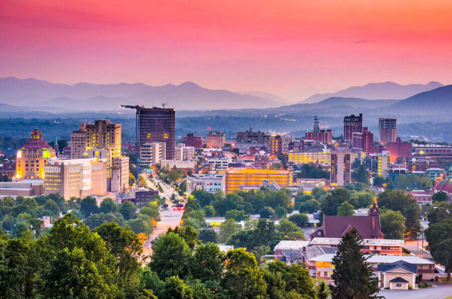 Sunset over the Blue Ridge Mountains in Asheville, North Carolina, casting warm hues across the sky and landscape.
