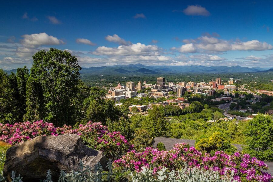 Scenic downtown Asheville, North Carolina, showcasing the stunning Blue Ridge Mountains in the distance.
