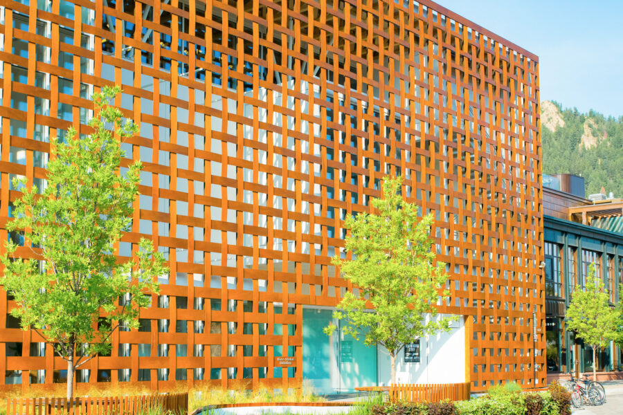 Exterior view of the Aspen Art Museum, showcasing its modern architecture against a backdrop of the Colorado mountains