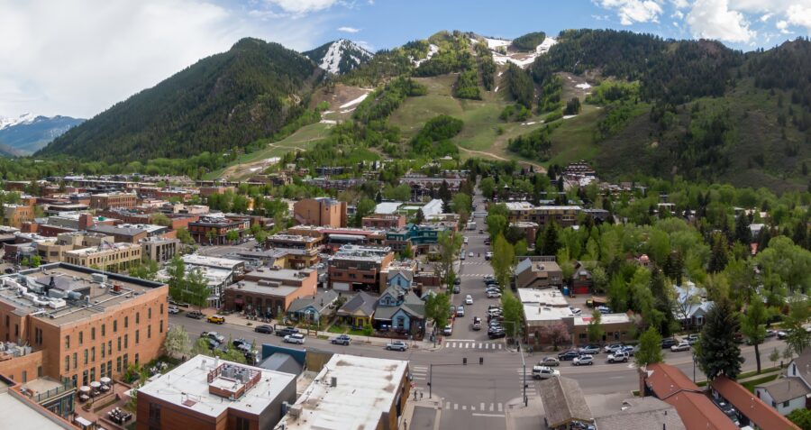 Aerial view of Aspen, Colorado, showcasing the ski town's charming architecture and surrounding snow-capped mountains