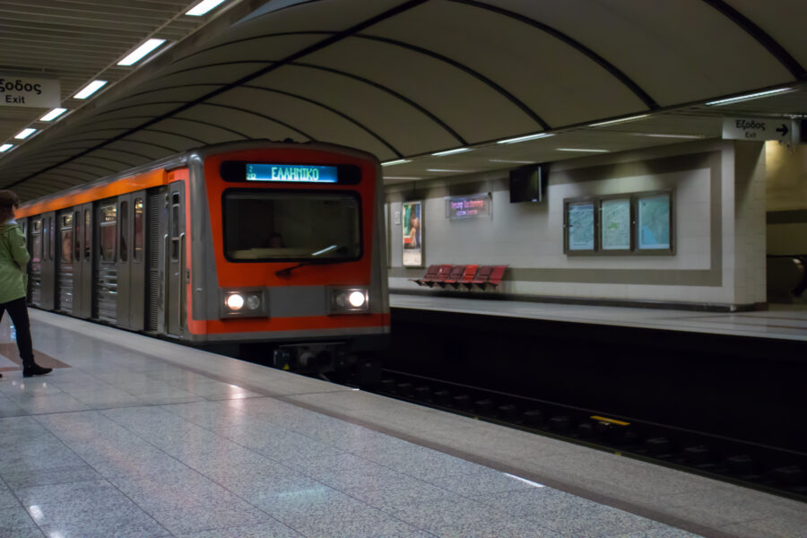 Interior view of an Athens metro station, featuring platforms and signage