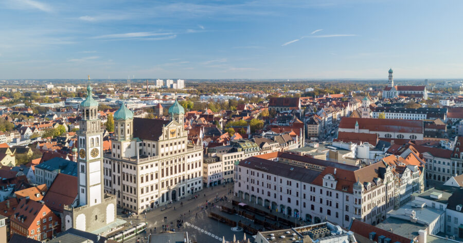 Aerial view of Augsburg, Bayern, showcasing the city's architecture and layout against a clear blue sky.