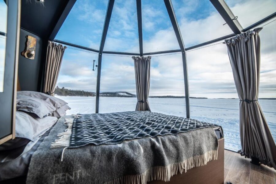 Inside a glass dome, a bed provides a breathtaking ocean view at the Aurora Borealis Observatory in Norway.

