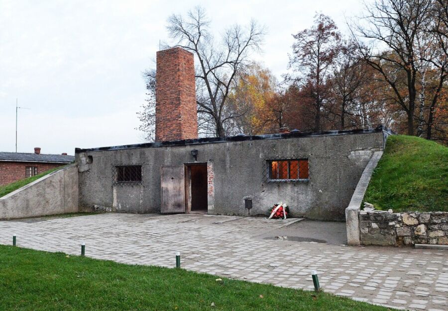The Auschwitz Gas Chamber, a small building featuring a brick chimney, representing a significant and tragic historical site.