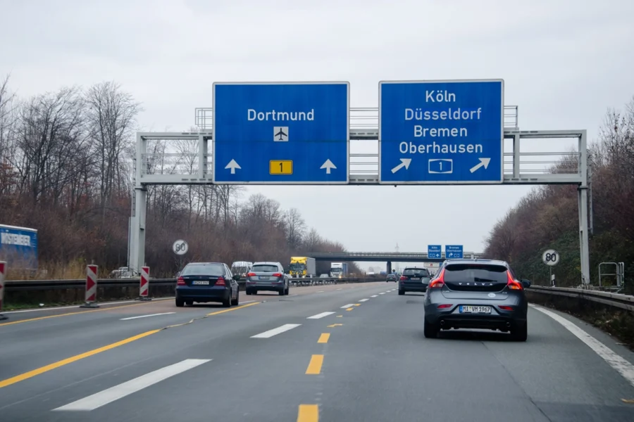 Autobahn highway overhead gantry signs for Dortmund and Köln guide traffic on German motorway.