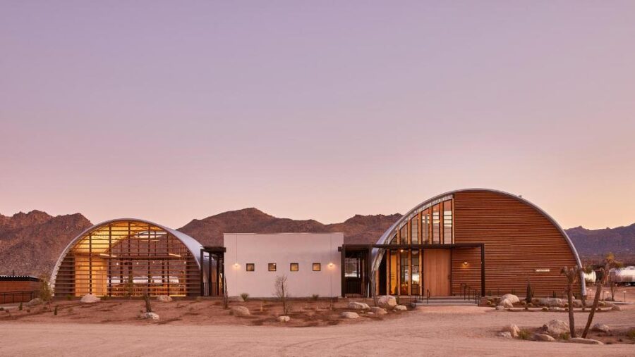 Exterior view of a wooden and metal house at AutoCamp Joshua Tree, showcasing contemporary architecture in a desert setting.