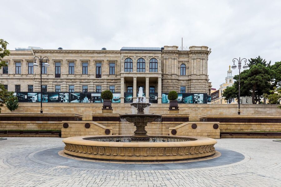 Azerbaijan National Museum of Art in Baku, featuring a large building with a fountain in front.