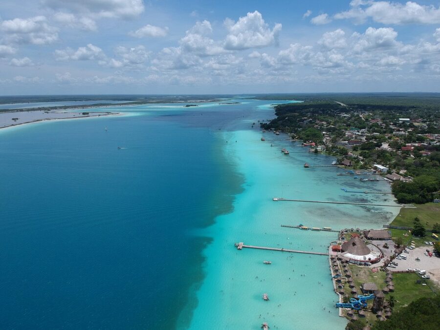 Aerial view of Bacalar, Quintana Roo, showcasing a beach and a small town nestled along the coastline.