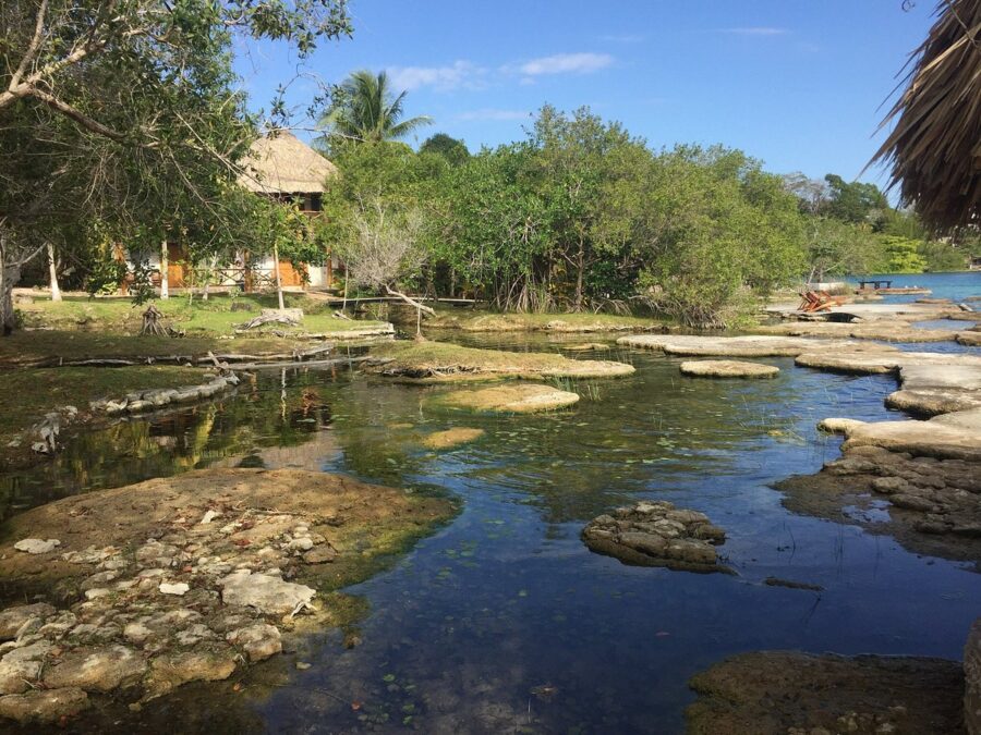 Tranquil small body of water surrounded by rocks, showcasing the natural beauty of Bacalar View.