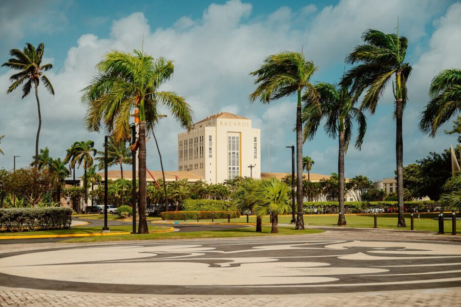 Casa Bacardí rum distillery building with bat logo plaza, palm trees, and tropical gardens.