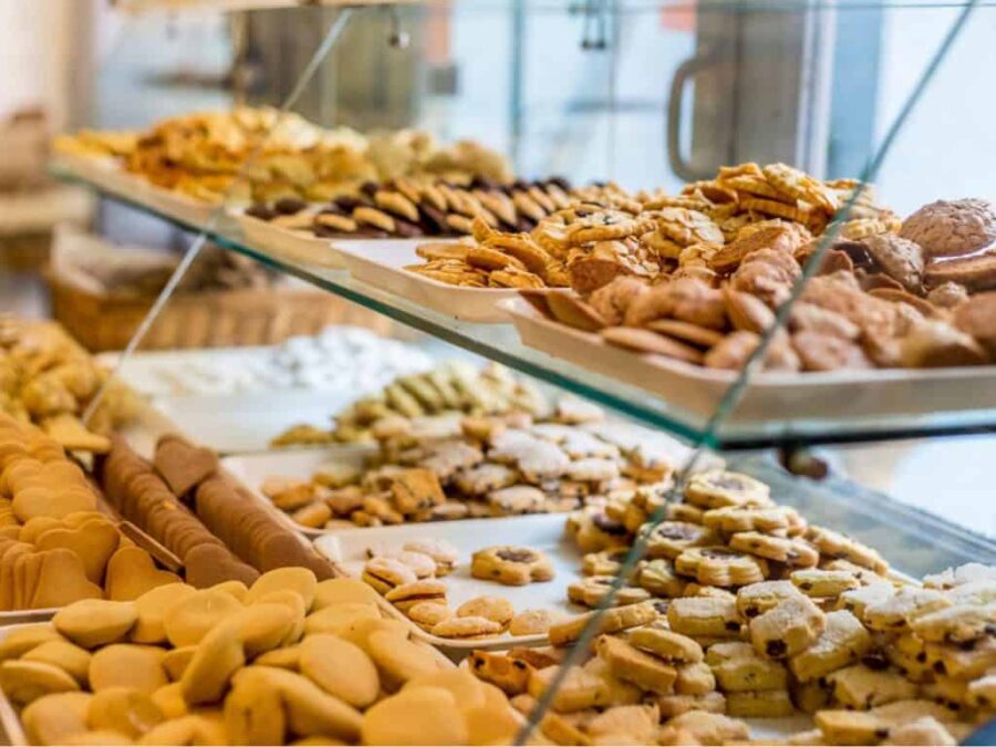 Artisanal bakery cookies and biscuits in a glass display case.
