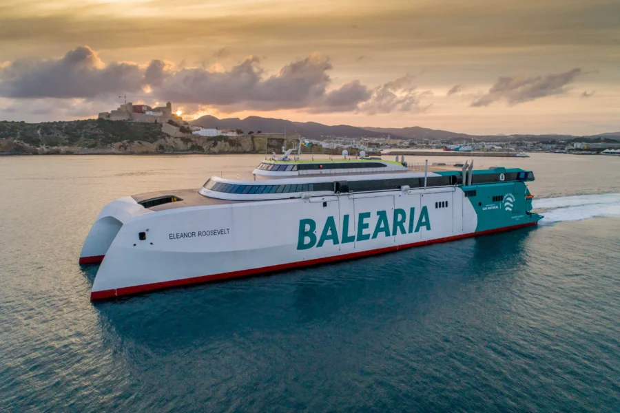 Balearia high-speed catamaran ferry Eleanor Roosevelt near Ibiza coast at sunset.