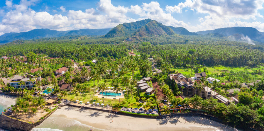 Panoramic aerial image of Candidasa shoreline in Bali, highlighting the resort, sandy beaches, and vibrant ocean