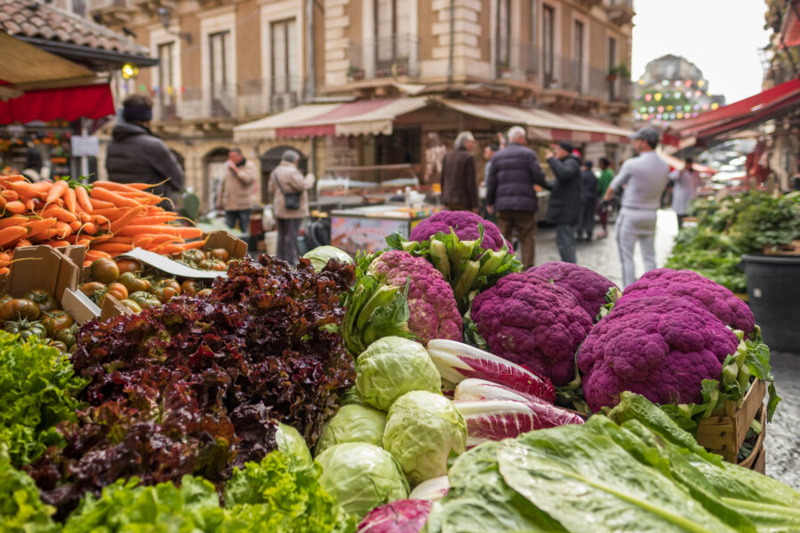 Fresh vegetables displayed at Ballaro market in Palermo, Sicily, showcasing vibrant colors and local produce