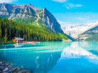 Scenic Lake Louise in Banff National Park, Canada, showcasing vibrant blue water and towering peaks in the background.