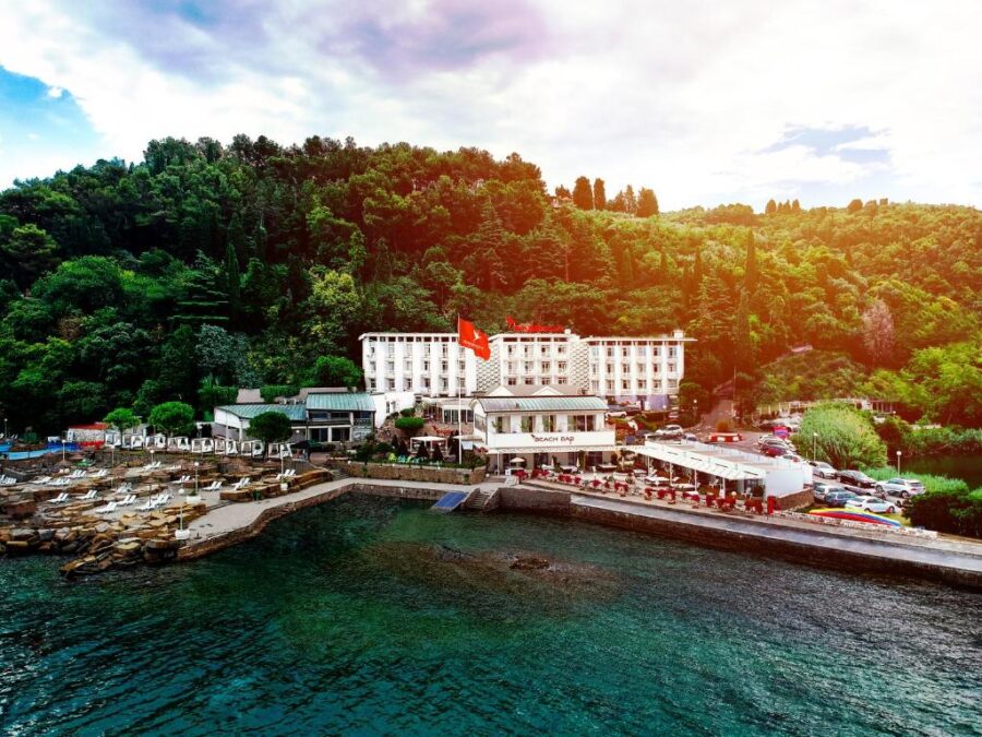 Barbara Piran Beach Hotel located on the ocean shore in Piran, Slovenia, with waves gently lapping at the beach.