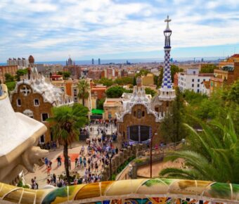 Aerial view of Park Güell in Barcelona, showcasing its colorful mosaics and unique architectural designs