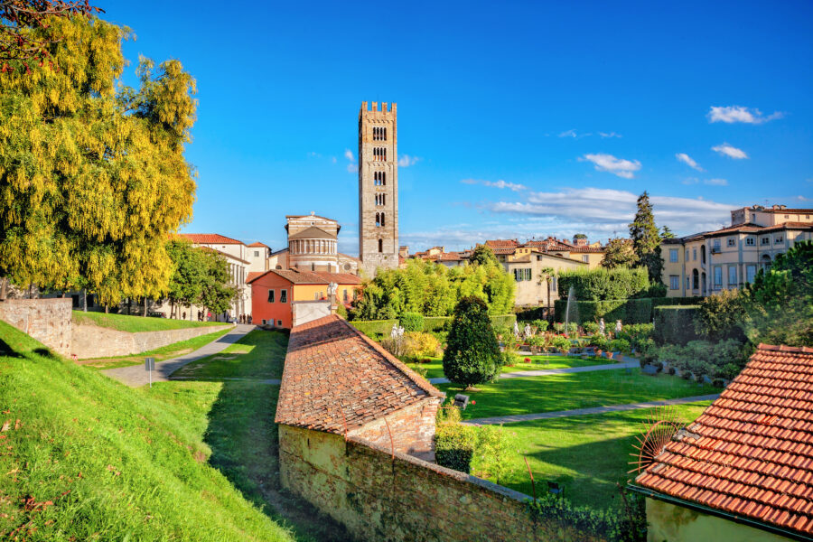Basilica di San Frediano with its bell tower, surrounded by the lush gardens of Palazzo Pfanner in Lucca, Tuscany, Italy