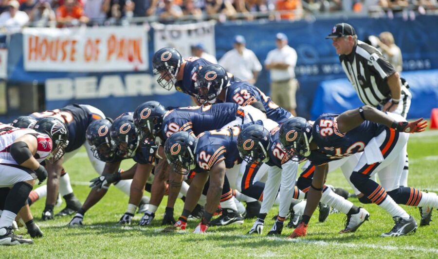 Chicago Bears vs Falcons in intense football game on vibrant, sunny field.