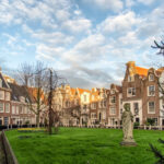 Sunset over Begijnhof, the oldest hofjes in Amsterdam, showcasing historic architecture and serene surroundings