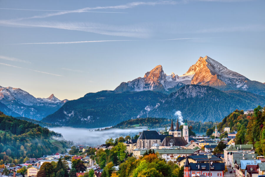 Scenic landscape featuring Berchtesgaden city nestled in the Bavarian Alps, with the prominent Mount Watzmann in the distance