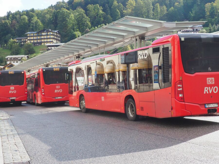 Red Deutsche Bahn public buses lined up at a station in Berchtesgaden, Germany