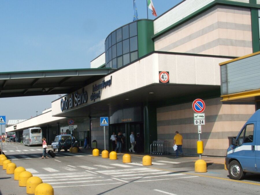 Bergamo Airport's white building stands prominently in the landscape