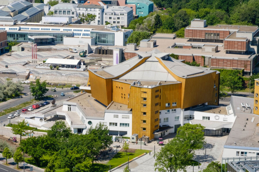 Aerial view of the Berliner Philharmonie building exterior, showcasing its unique architecture and surrounding green spaces in Berlin