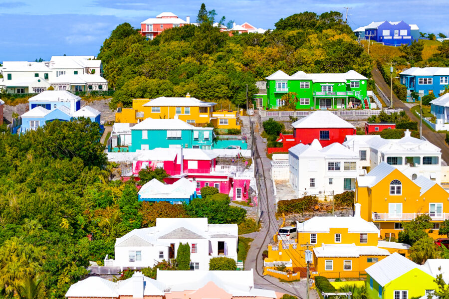 Aerial view of colorful houses on Bermuda Island, showcasing vibrant architecture against a clear blue sky.