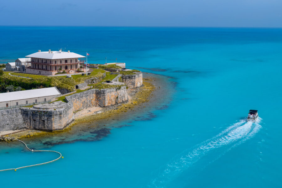 King's Wharf in Bermuda, featuring lively waterfront shops and restaurants, with cruise ships docked nearby.