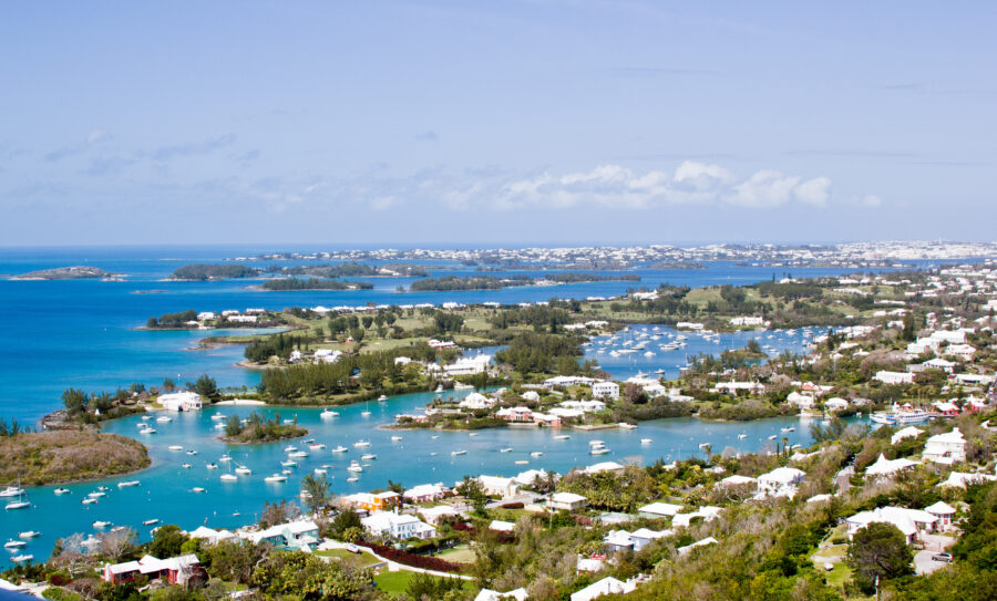 Scenic panorama of Bermuda showcasing vibrant houses and sailboats against a backdrop of calm waters.