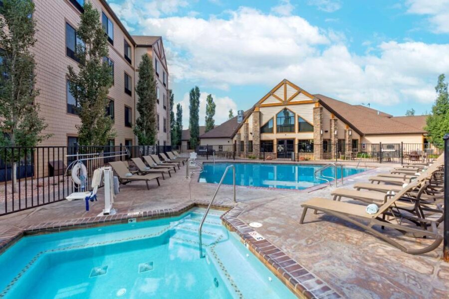 The pool at the Holiday Inn Express in Denver, featuring clear water and lounge chairs around the edge.