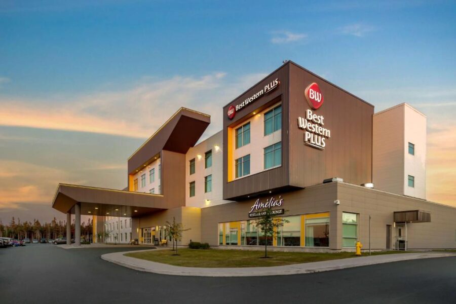 Front view of Best Western Plus St. John's Airport Hotel and Suites in Houston, featuring welcoming entrance and branding.