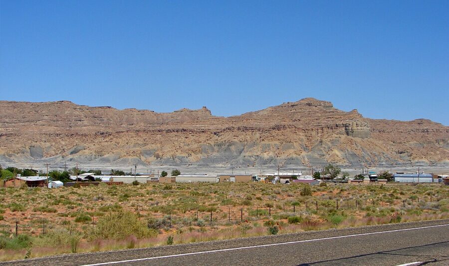 Scenic view of a highway in Big Water, Utah, framed by a towering mountain in the distance.