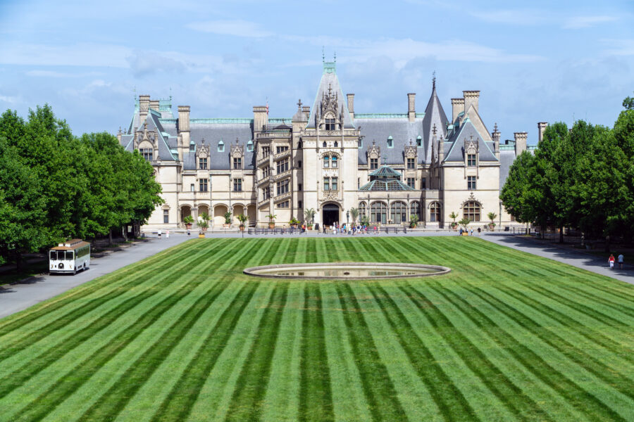 Scenic view of Biltmore Estate, a historic house museum in Asheville, North Carolina, surrounded by lush gardens and mountains.