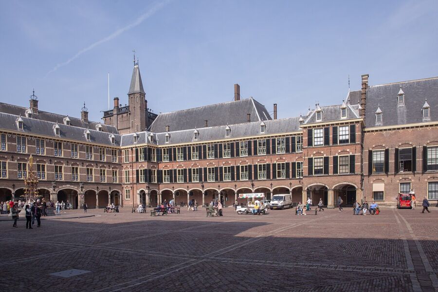 The Binnenhof in The Hague features a prominent clock tower at its center, surrounded by historic architecture.