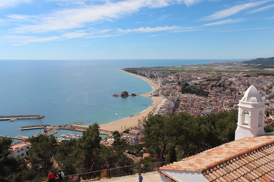 Panoramic view of Blanes, Costa Brava, featuring a bustling harbor and a picturesque beach.