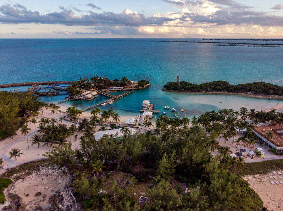 Scenic view of Blue Lagoon Island in Nassau, Bahamas, featuring turquoise waters and lush tropical vegetation.