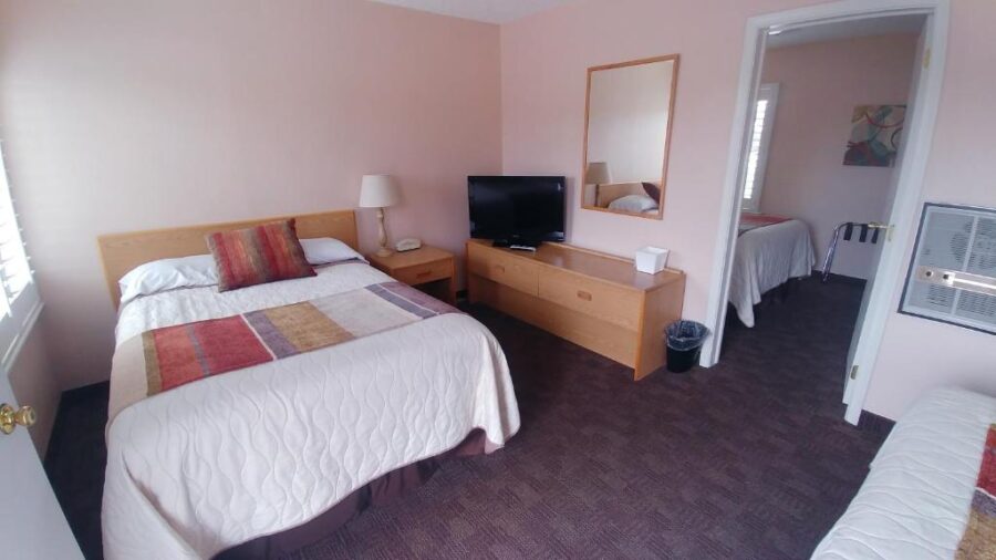 Interior of a inn room at Blue Pine Motel, showcasing two inviting beds and a relaxed atmosphere.