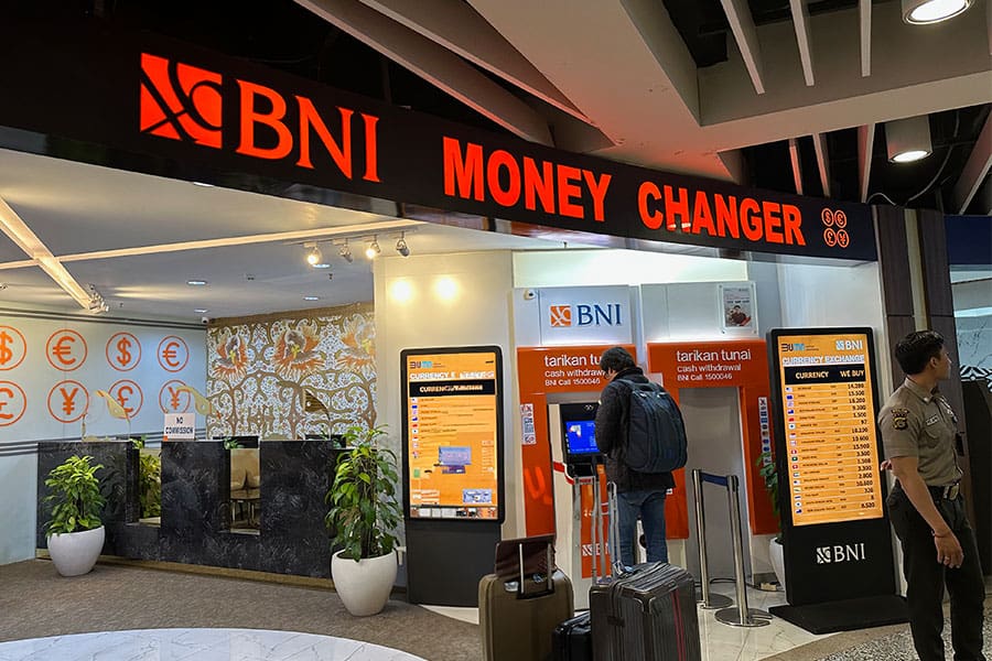 BNI currency exchange area with digital kiosks and currency rates in a modern, welcoming setting.