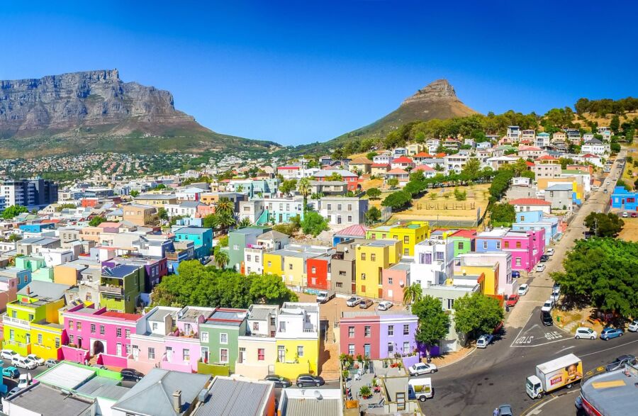 Colorful Bo-Kaap neighborhood with vibrant houses and Table Mountain in the background.