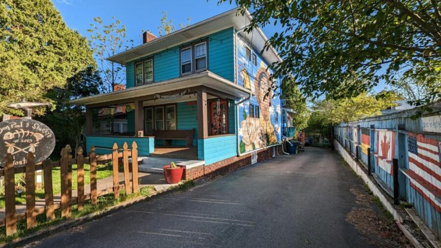 Bon Paul & Sharky’s Hostel, a blue house with a fence, located in Asheville, North Carolina.