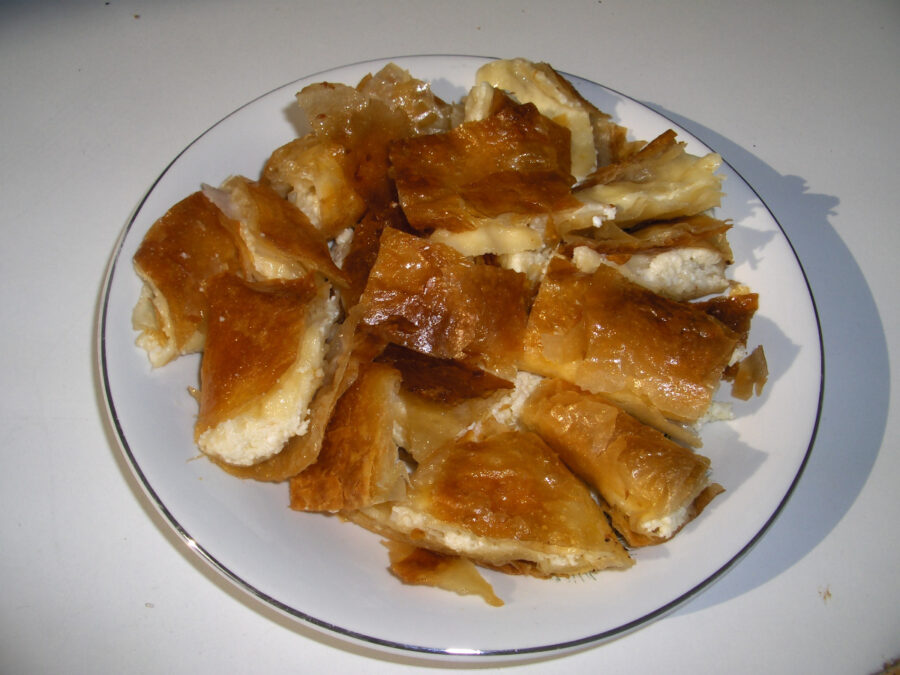 Close-up of Bougatsa, a Greek pastry filled with custard, topped with powdered sugar and cinnamon