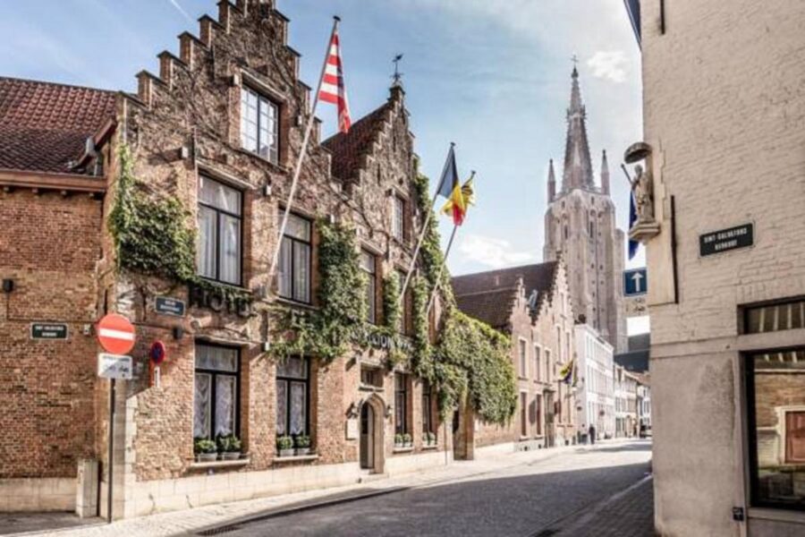 Boutique Hotel De Castillion building exterior in Bruges, showcasing its charming architecture and inviting entrance.