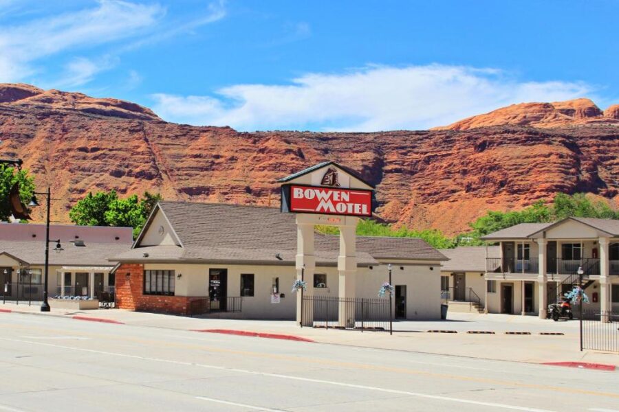 Bowen Motel in Moab, featuring a vibrant red mountain in the background.