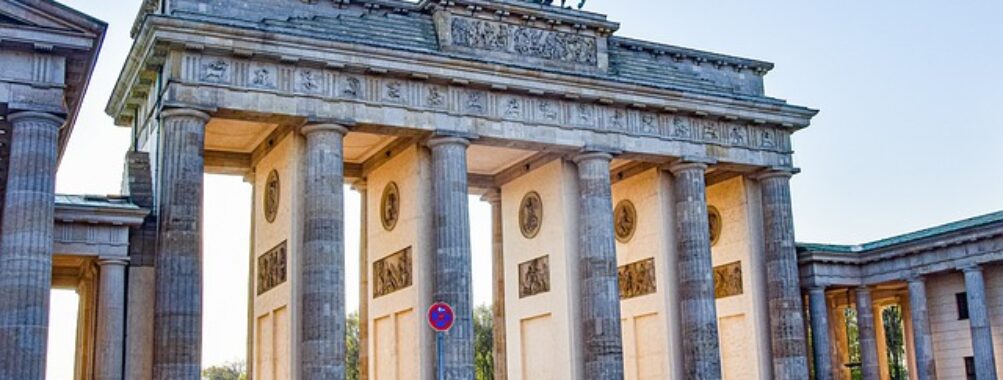 Brandenburg Gate in Berlin with tourists enjoying the iconic neoclassical monument.